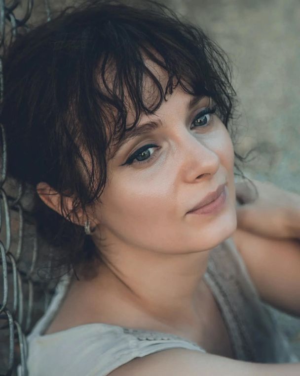 Olya leaning back in soft daylight